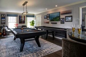 full game room with pool table, shuffleboard and a bar